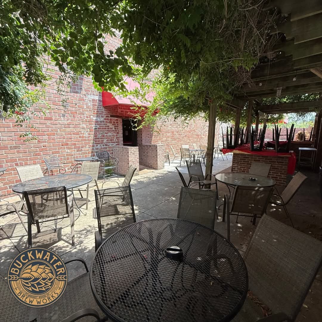 213 East Main Street Carbondale, IL 62901 - Photo 3 of 17 a view of a patio with table and chairs with plants and wooden fence