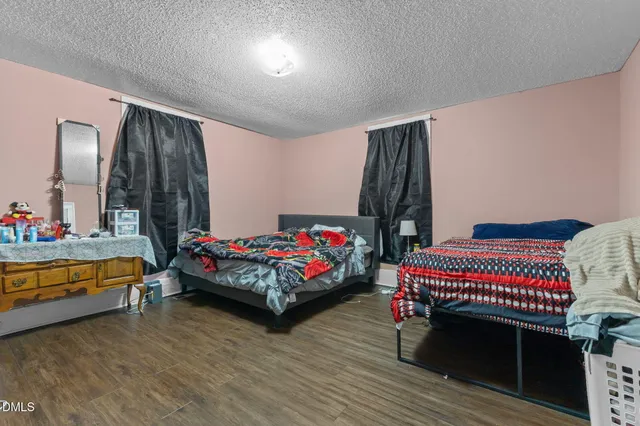 a bedroom with a bed and a dresser