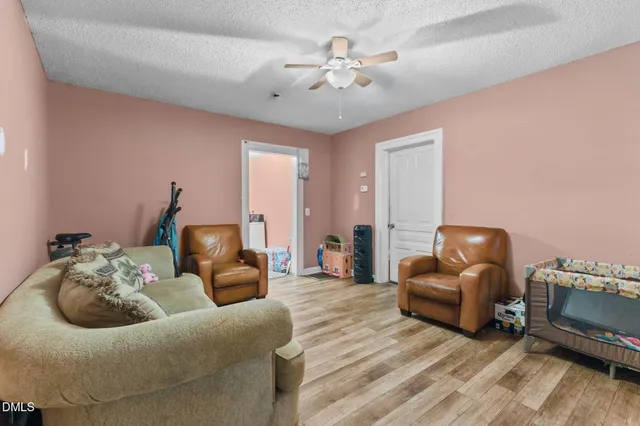 a living room with furniture and a chandelier
