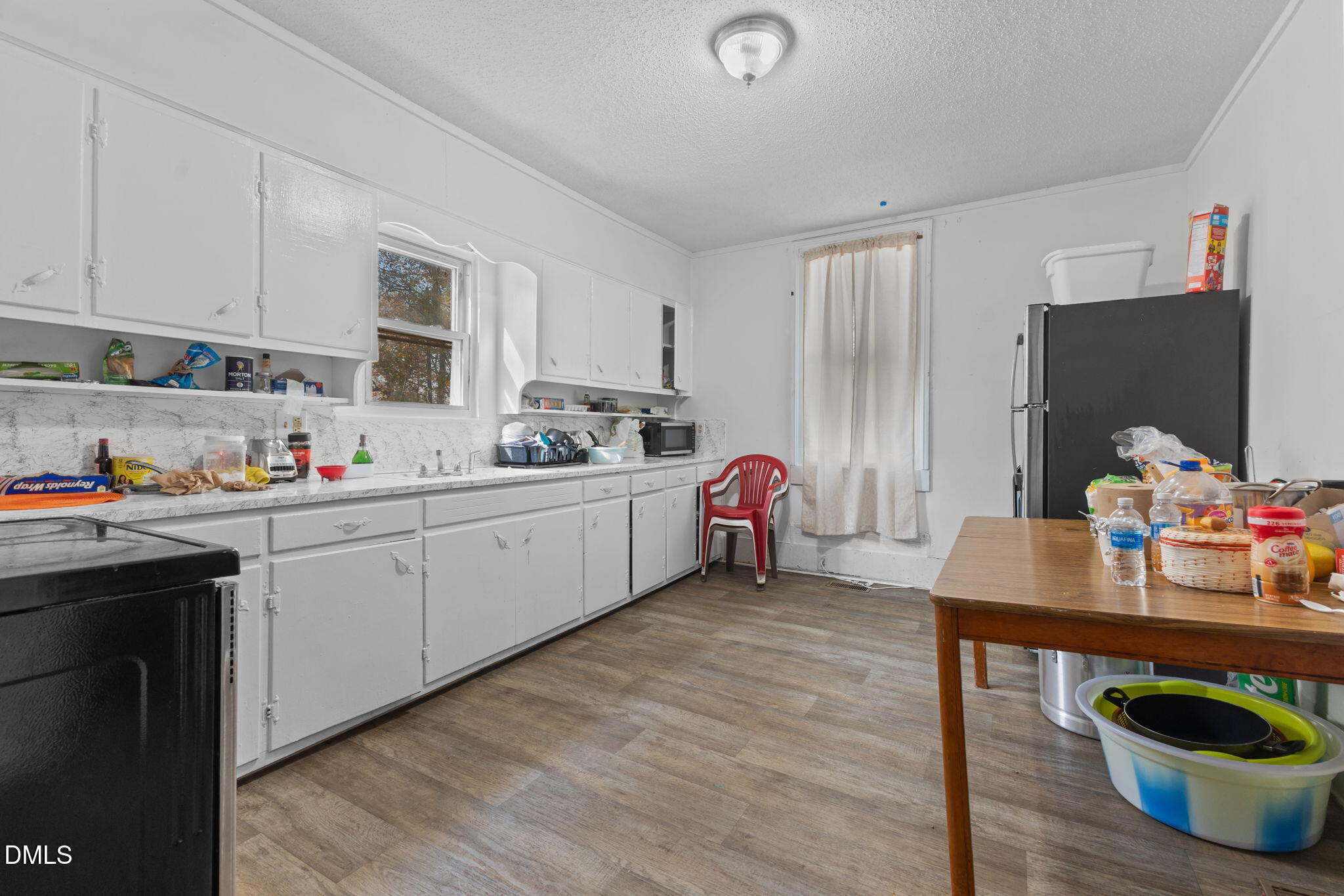300 Devane Street Clinton, NC 28328 - Photo 25 of 39 a open kitchen with sink cabinets and wooden floor