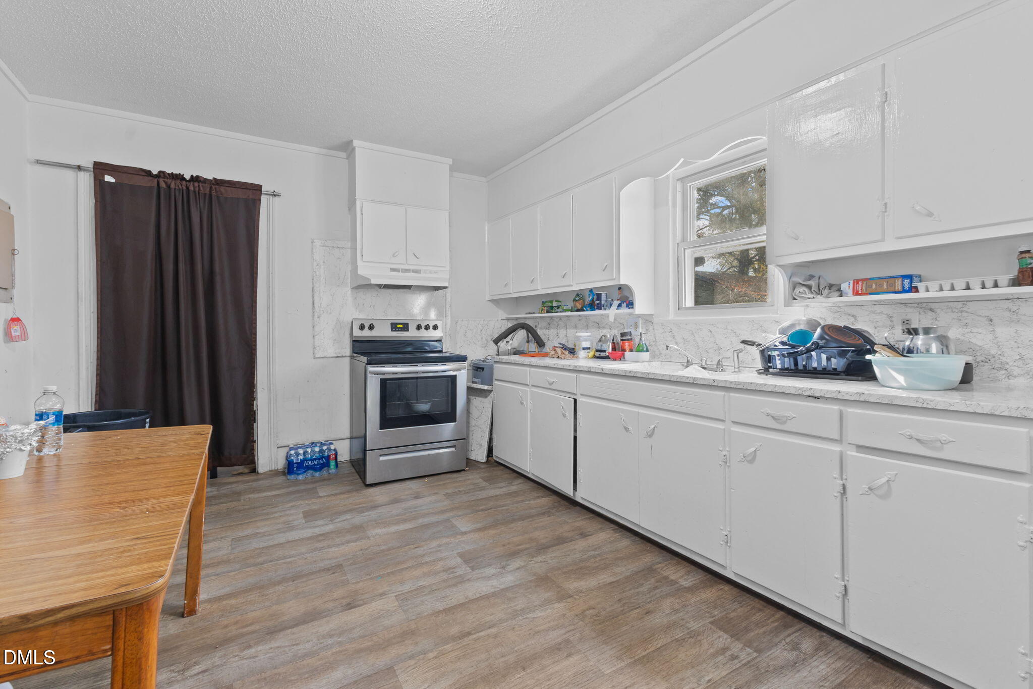 300 Devane Street Clinton, NC 28328 - Photo 27 of 39 a kitchen with stainless steel appliances granite countertop a refrigerator sink and cabinets