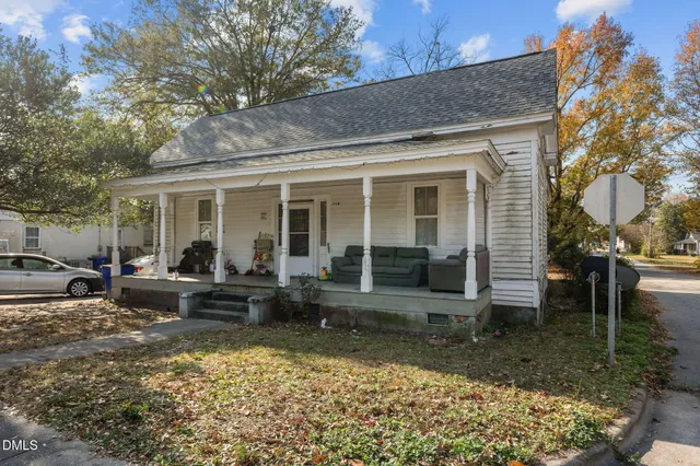 a view of a house with backyard sitting area and garden