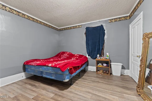 a bedroom with a bed and a mirror