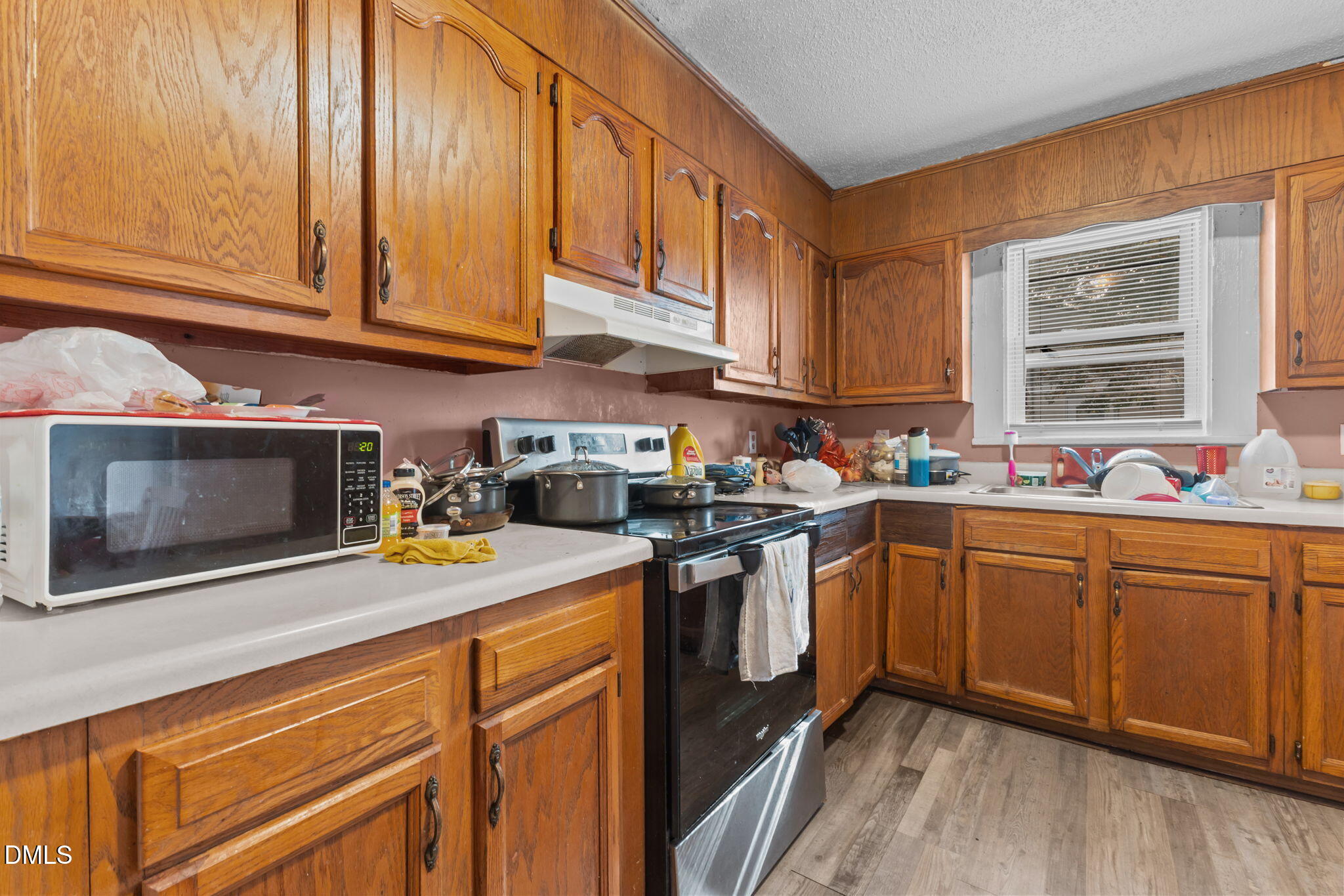 300 Devane Street Clinton, NC 28328 - Photo 8 of 39 a kitchen with stainless steel appliances granite countertop a sink stove and microwave