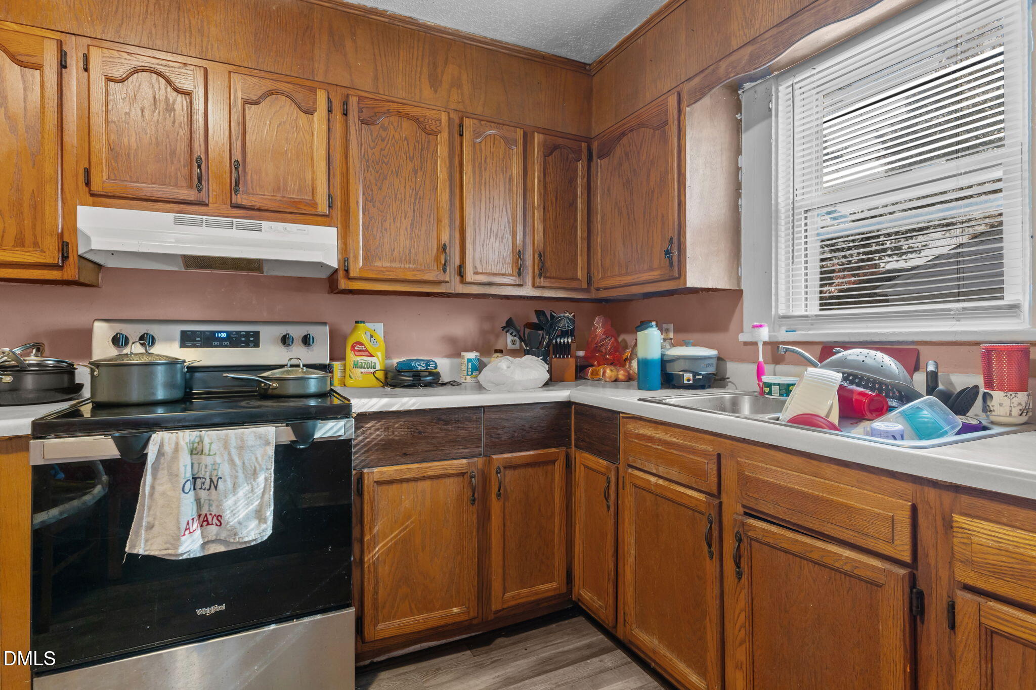 300 Devane Street Clinton, NC 28328 - Photo 9 of 39 a kitchen with stainless steel appliances granite countertop a refrigerator and sink
