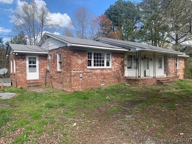 159 Reynolds Farm Road Lancaster, VA 22503 - Photo 2 of 2 View of front of house with brick siding, crawl space, a front lawn, and a porch