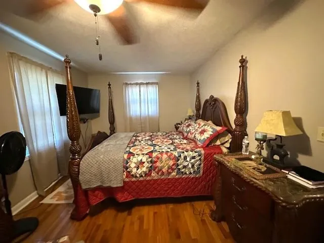 a bed sitting in a bedroom next to a window with tv