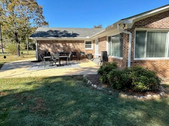 a view of a house with backyard porch and sitting area