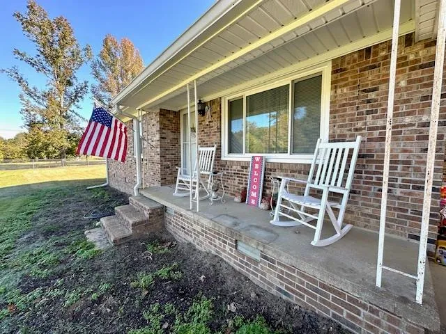 a chairs and table in the backyard of the house