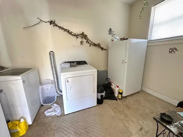 a view of storage and utility room with two washing machine