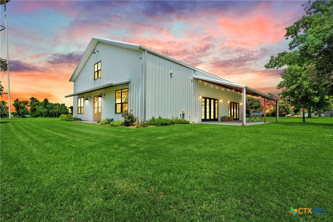 1006 County Road 280 Cameron, TX 76520 - Photo 11 of 48 a front view of a house with a garden