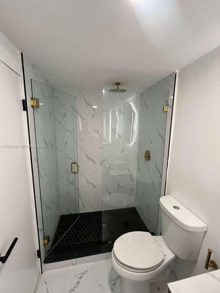 316 Surfside Boulevard, Unit 2 Surfside, FL 33154 - Photo 13 of 13 a bathroom with a toilet and a shower