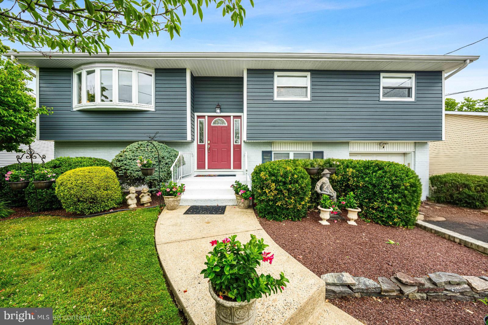 Charming split-level home with lush greenery.