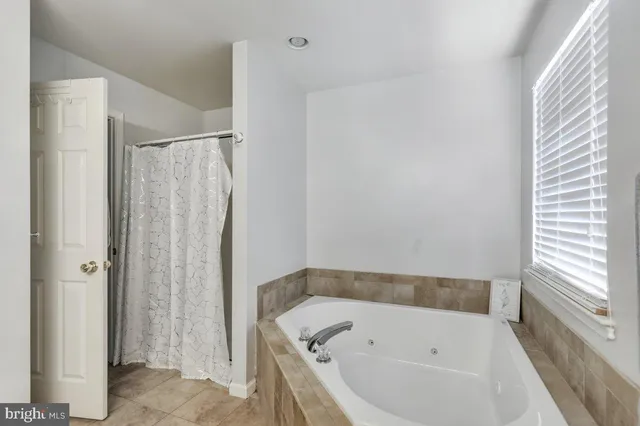 a bathroom with a bathtub and shower
