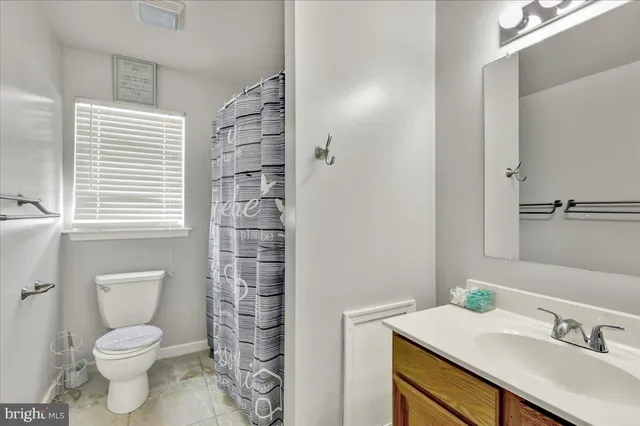 a bathroom with a sink toilet vanity and shower