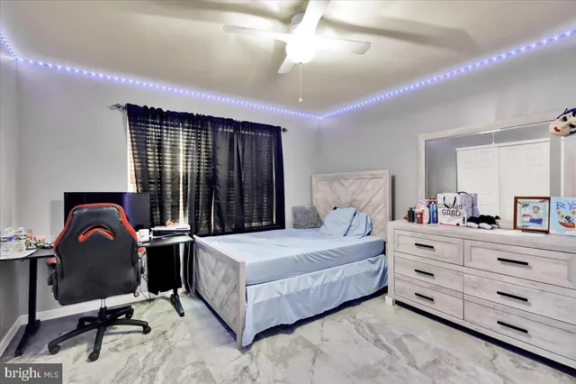 a bedroom with a bed and a desk