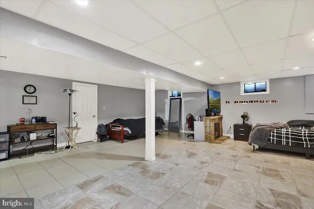 a bedroom with furniture and a window