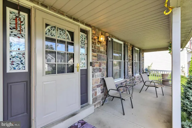 a balcony with table and chairs