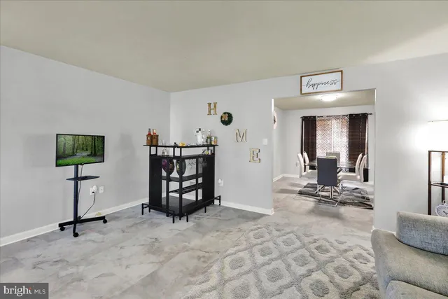 a view of a livingroom with furniture and a flat screen tv