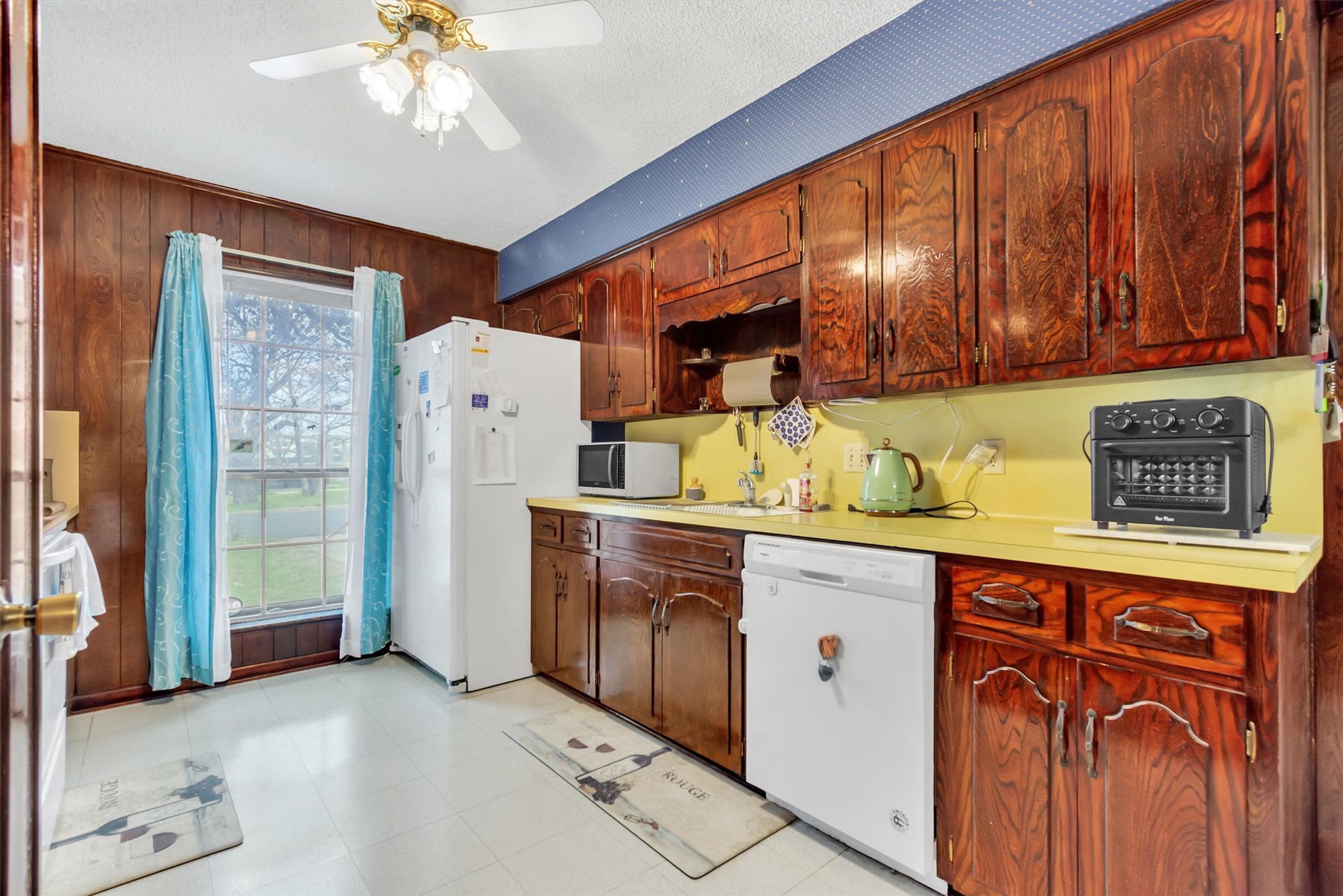 3100 Blue Ridge Drive Cedar Park, TX 78613 - Photo 11 of 34 a kitchen with stainless steel appliances granite countertop a refrigerator a sink dishwasher and wooden cabinets with wooden floor