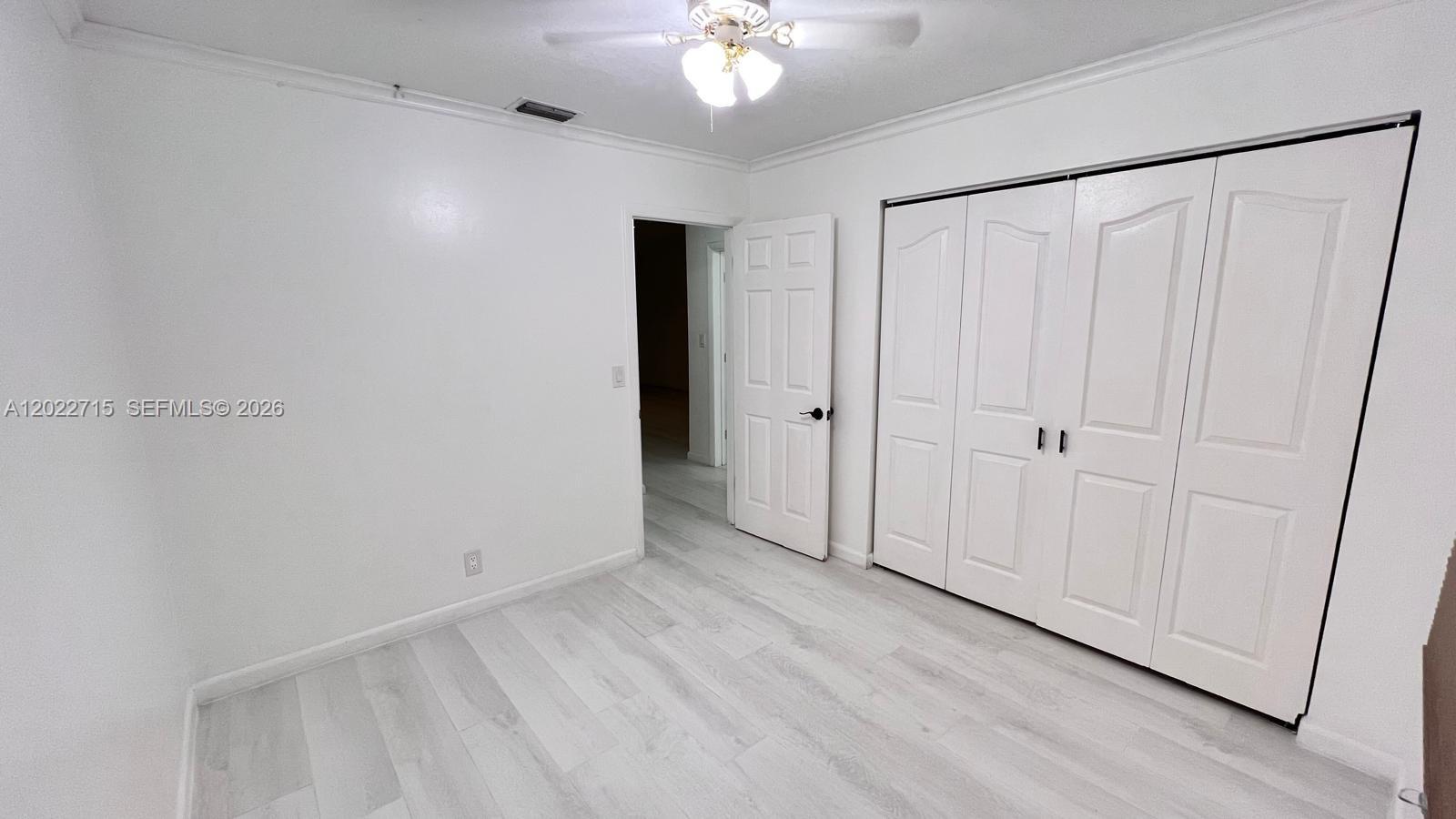 10669 Boca Entrada Boulevard Boca Raton, FL 33428 - Photo 16 of 19 a view of an empty room with wooden floor
