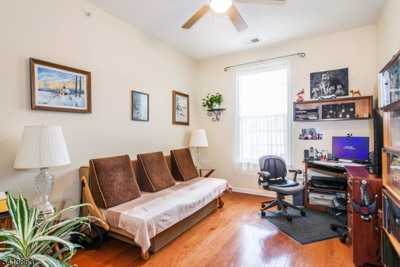9 Cliff Road, Unit D3 Woodland Park, NJ 07424 - Photo 6 of 25 a living room with furniture a rug and a lamp