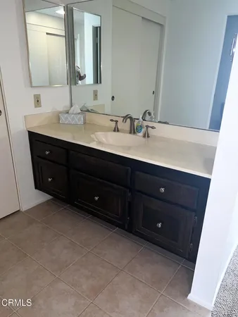 a bathroom with a sink vanity and mirror