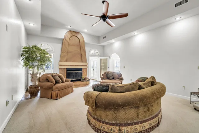 a kitchen with stainless steel appliances kitchen island granite countertop a table chairs in it and wooden floors