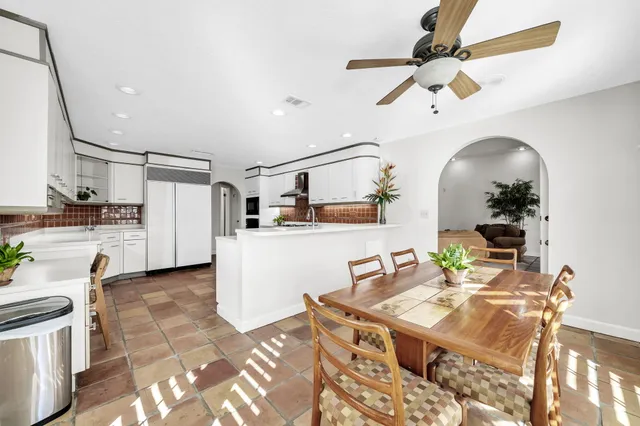 a kitchen with stainless steel appliances kitchen island granite countertop a refrigerator and a stove