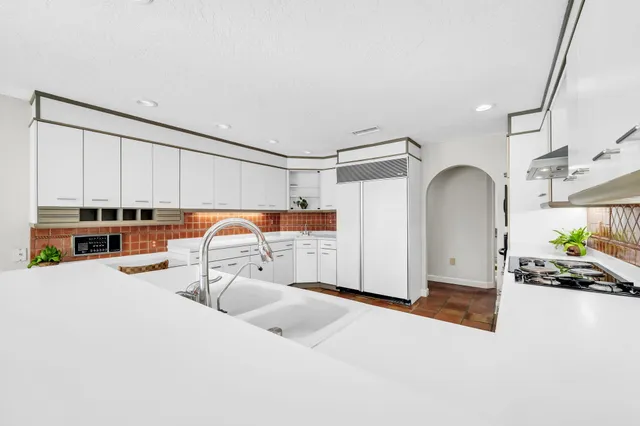 a kitchen with granite countertop appliances cabinets and furniture