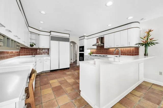 a spacious bedroom with a bed couch and a window
