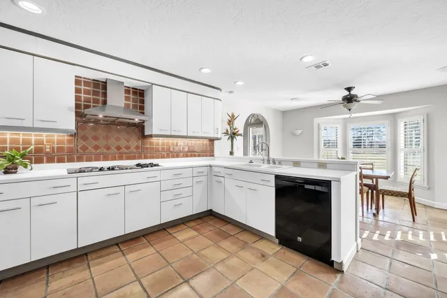 a bedroom with a bed a dresser and flat screen tv