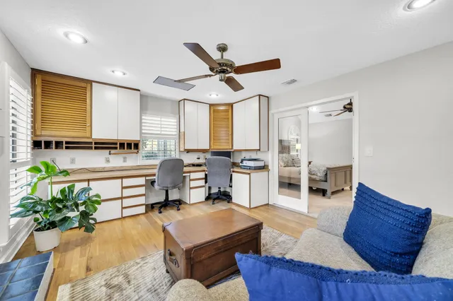 a spacious bathroom with a granite countertop sink a toilet a mirror and bathtub