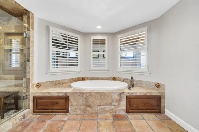 a bathroom with a bathtub and a shower