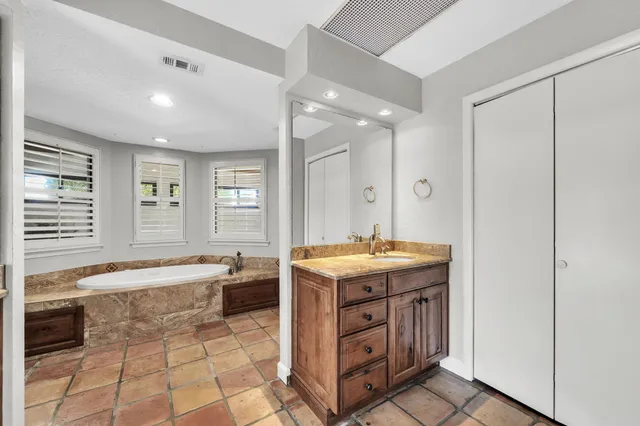 a living room with furniture a chandelier fan and a window