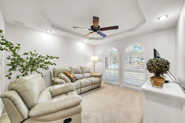 a spacious bedroom with a large bed and a chandelier