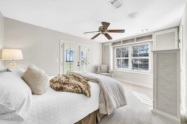 a spacious bedroom with a bed and a chandelier