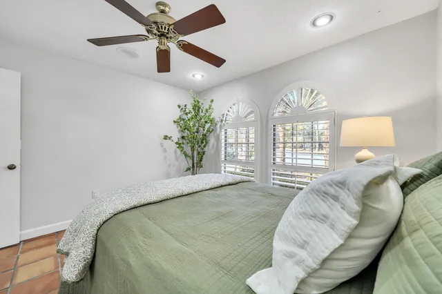 a view of a livingroom with lounge chair and a large window