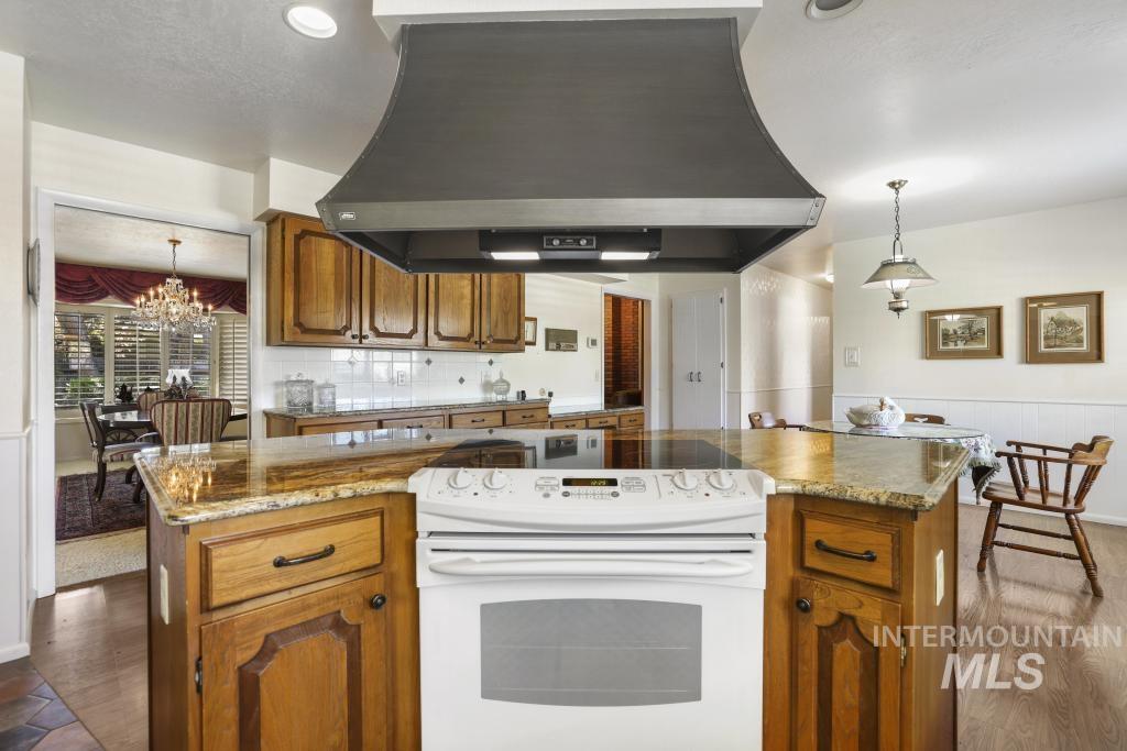 2018 Rancho Vista Drive Twin Falls, ID 83301 - Photo 14 of 50 Kitchen island with integrated electric range and overhead ventilation hood