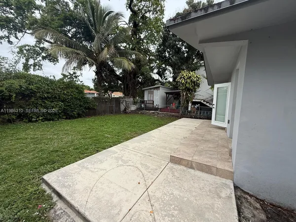 a view of a backyard with a garden and trees