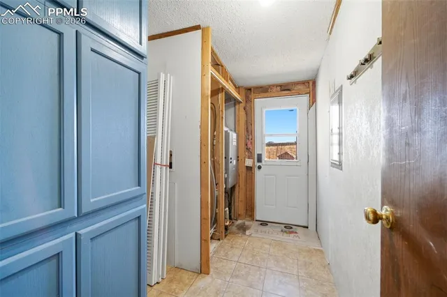 a view of a hallway with closet and front door