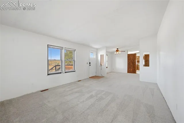 a view of a big room with closet and windows