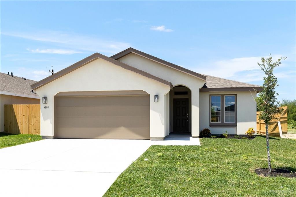 a front view of a house with a garden and yard