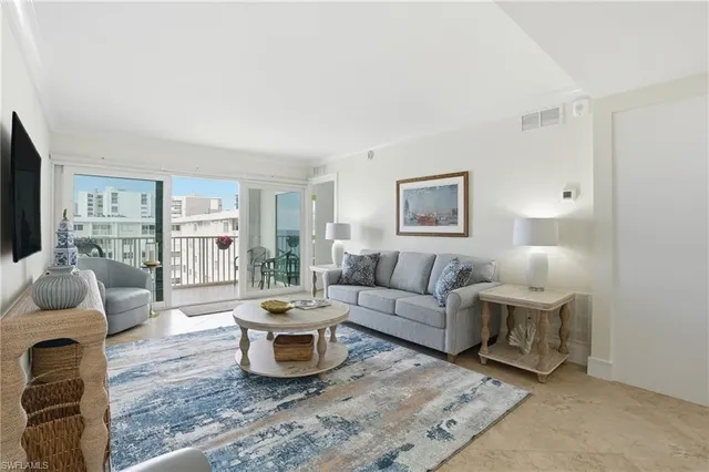 a view of a dining room with furniture and a potted plant