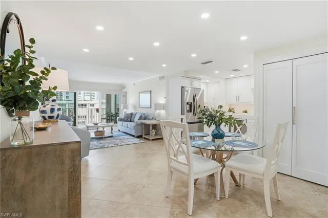 a living room with furniture a view of bedroom and a couch
