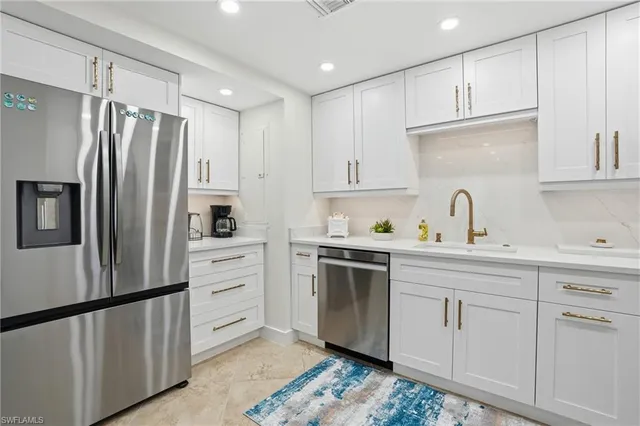 a kitchen with sink cabinets and stainless steel appliances