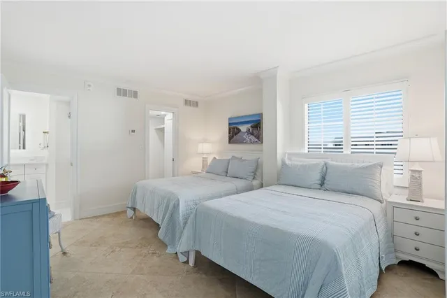 a bedroom with a bed and a view of bathroom