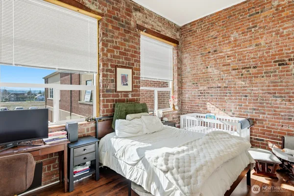 a bed sitting in a bedroom next to a computer on a desk