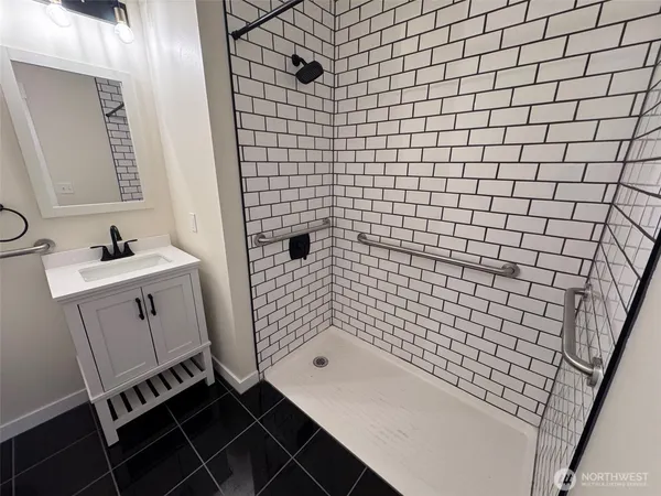 a bathroom with a bathtub and shower