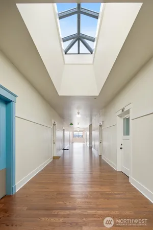 a view of empty room with wooden floor